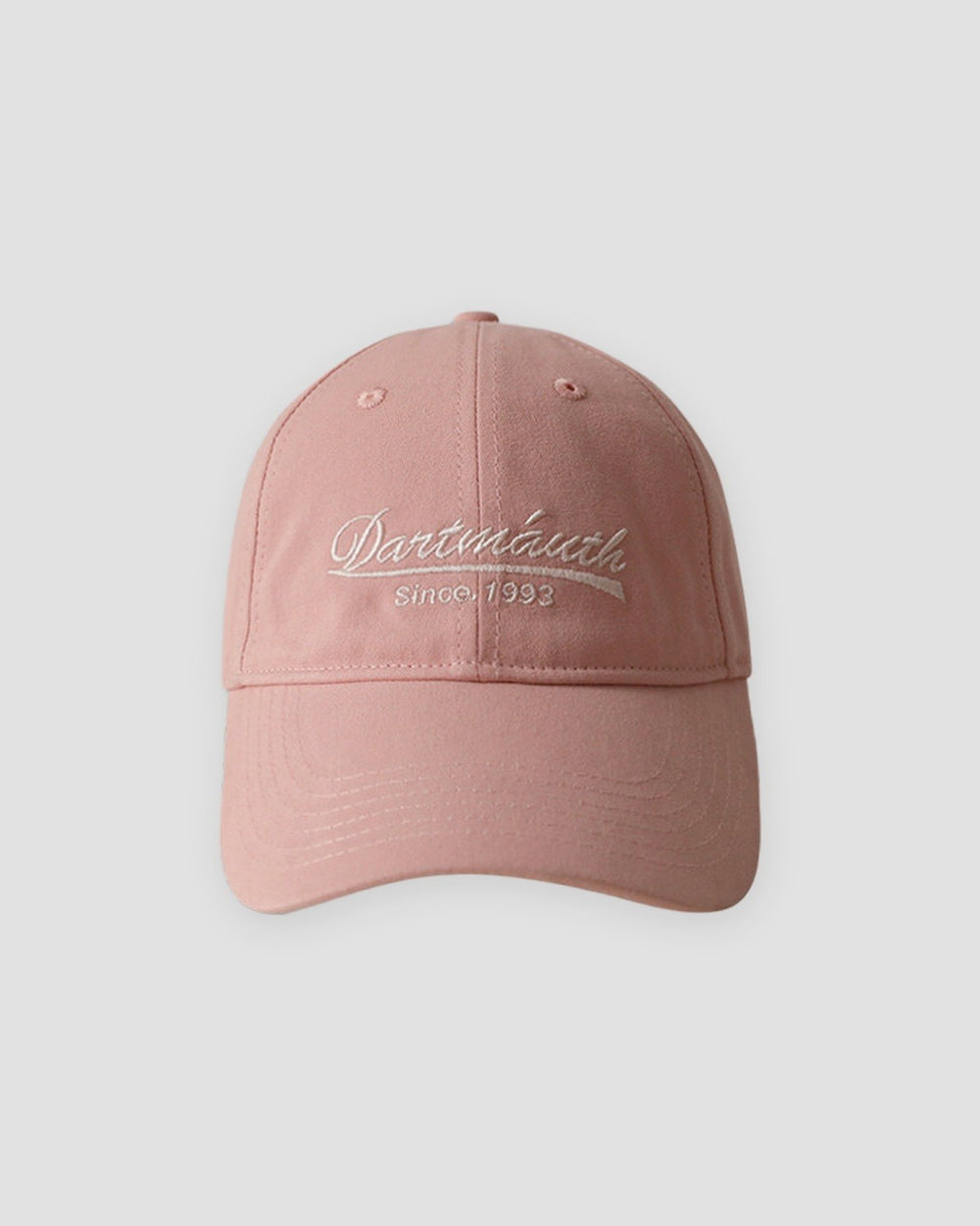 Pink dad cap with pale cursive script embroidery, front view