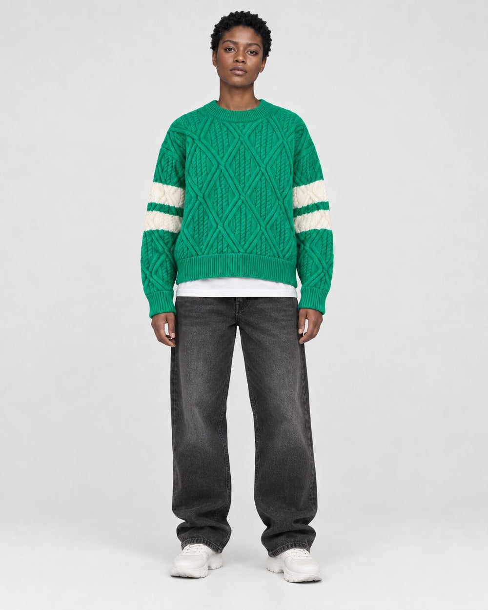 Model wearing the green cable knit sweater, front view
