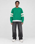 Model wearing the green cable knit sweater, front view