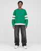 Model wearing the green cable knit sweater, front view