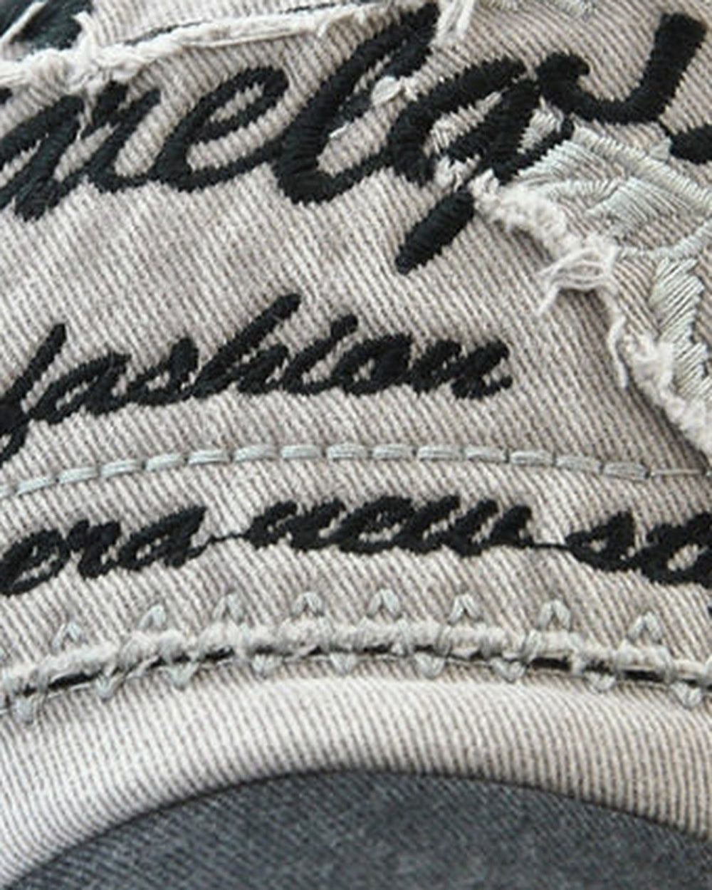 Close-up of the embroidered script lettering on the frayed patch