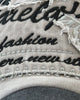 Close-up of the embroidered script lettering on the frayed patch