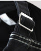 Close-up of the adjustable back strap and metal buckle