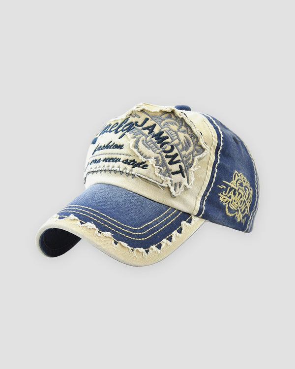 Denim blue distressed patch cap, three-quarter view, gold emblem on the side