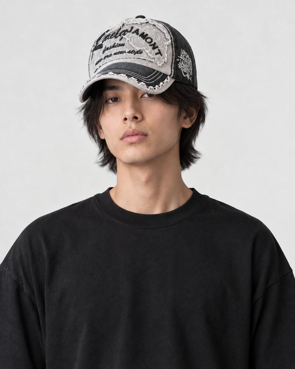 Model wearing the black distressed patch cap, side profile