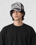 Model wearing the black distressed patch cap, side profile