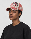Model wearing the washed red distressed patch cap, three-quarter view