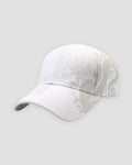White baseball cap with a pale taupe dragon printed across the side and calligraphy on the brim