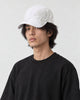 Man wearing the white dragon print cap, the pale dragon wrapping the side of the crown