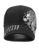 Black baseball cap, side view of the white dragon embroidery and brim lettering