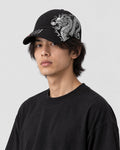 Model wearing the black dragon embroidered cap, three-quarter view
