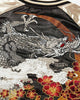 Close-up of the embroidered dragon head, clouds and red peonies
