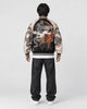 Model wearing the black and apricot dragon bomber, back view