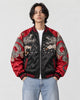 Model wearing the black and red dragon bomber half zipped, front view