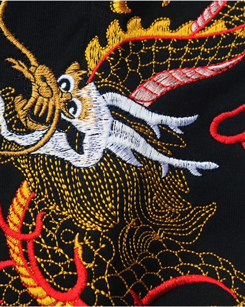Close-up of the dragon's head embroidered in gold, red and white thread