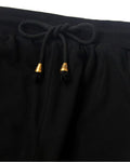 Close-up of the elastic waist and the drawcord with gold metal tips