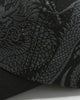 Close-up of the gray dragon print on the black cap