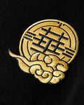 Close-up of the small gold seal embroidered on the chest