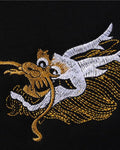 Close-up of the small gold and white dragon head embroidered on the chest