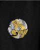Close-up of the gold and silver wave emblem stitched on the chest