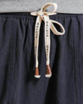 Close-up of the cream drawstring printed with black characters