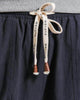 Close-up of the cream drawstring printed with black characters