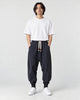 Model wearing the navy drop-crotch harem pants, front view