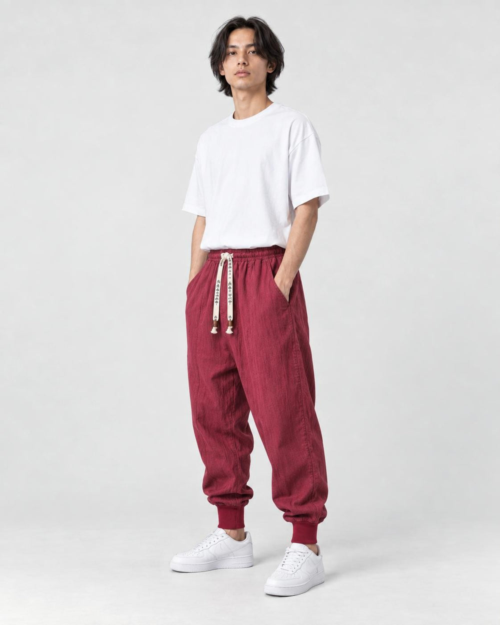 Model wearing the wine red harem pants, three-quarter view
