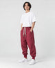 Model wearing the wine red harem pants, three-quarter view
