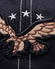 Close-up of the raised embroidered eagle under three white stars
