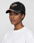 Model wearing the black eagle embroidered baseball cap, three-quarter view