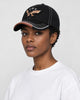 Model wearing the black eagle embroidered baseball cap, three-quarter view