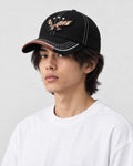 Model wearing the black eagle embroidered cap, three-quarter view