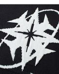 Close-up of the star and ring knitted into the black sweater