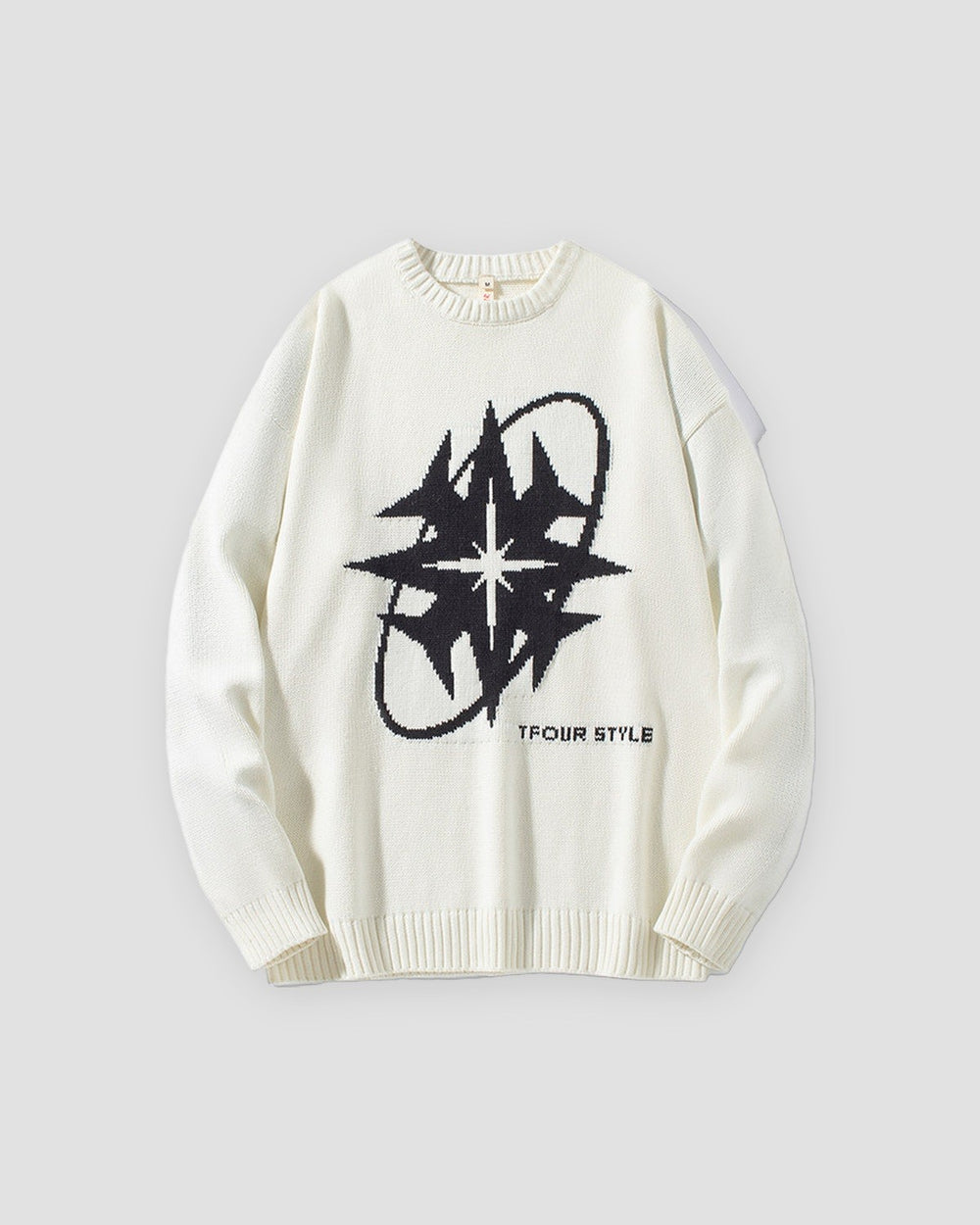 White knit sweater with a large black eight-point star and ring