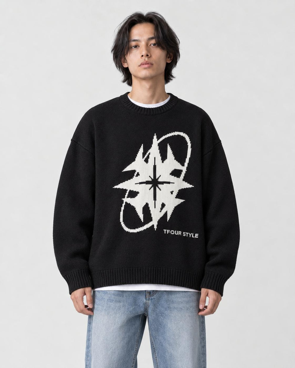 Model wearing the black star knit sweater with jeans, front view