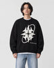 Model wearing the black star knit sweater with jeans, front view