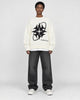 Model wearing the white star knit sweater, front view
