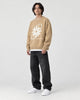 Model wearing the khaki star knit sweater, three-quarter view