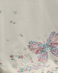 Close-up of the embroidered butterfly and blossoms on the white tee