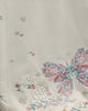 Close-up of the embroidered butterfly and blossoms on the white tee