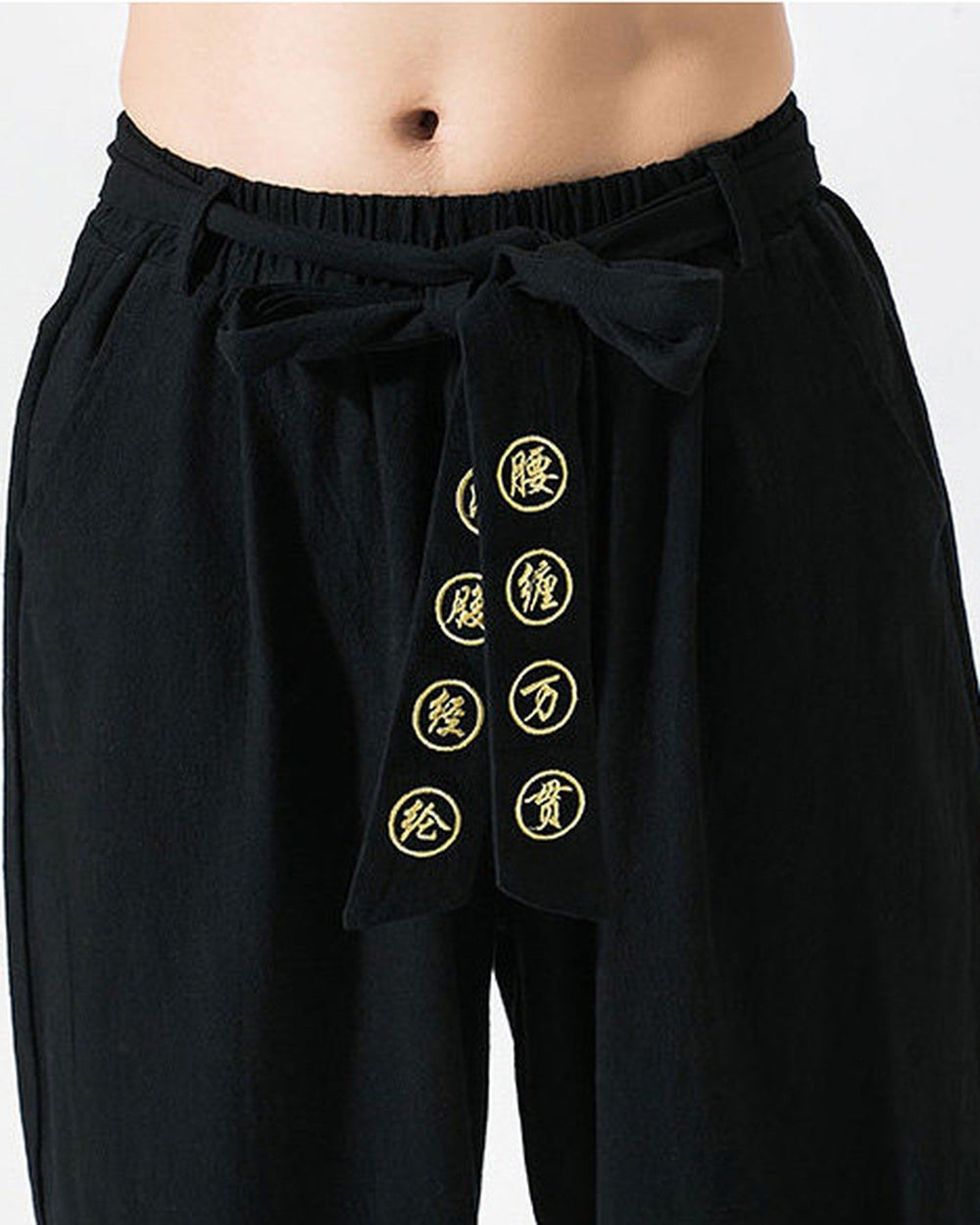 Close-up of the sash bow and the eight gold medallions on the black pants