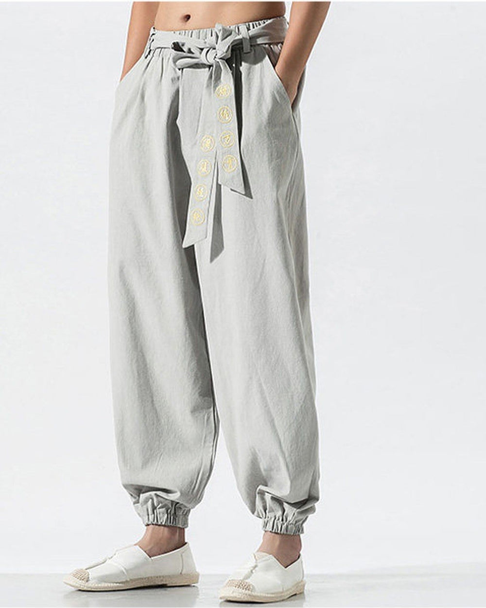 Light gray harem pants with the embroidered sash and gathered ankle cuffs, front view
