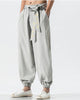 Light gray harem pants with the embroidered sash and gathered ankle cuffs, front view