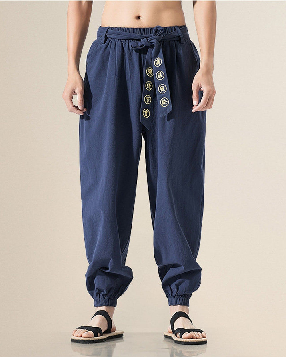 Navy harem pants with the embroidered sash tied at the waist, front view