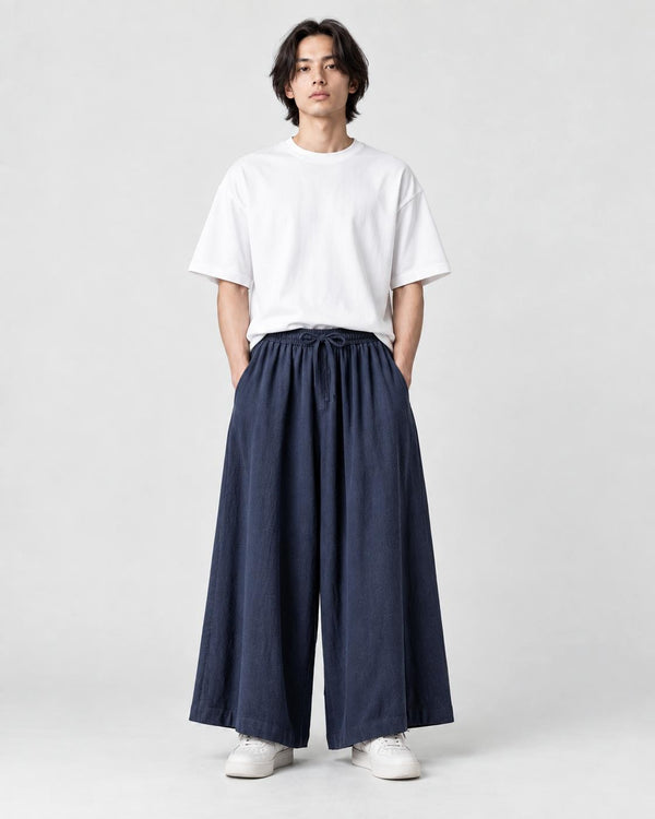 Model wearing the navy extra-wide linen-cotton skirt pants with a white tee and white sneakers, front view