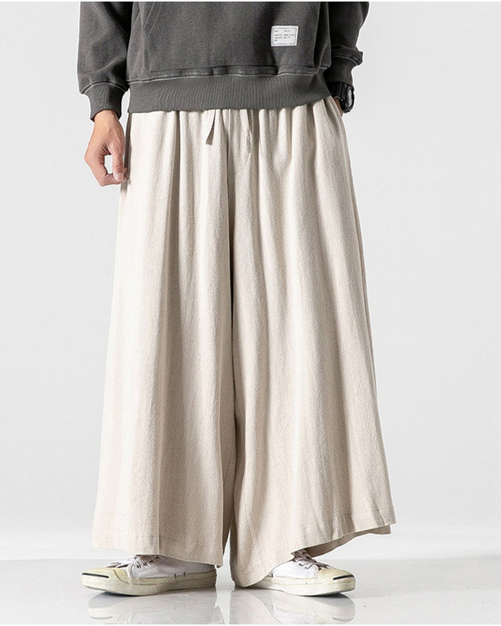 Cream extra-wide linen-cotton skirt pants worn with a dark gray sweatshirt, front view