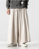 Cream extra-wide linen-cotton skirt pants worn with a dark gray sweatshirt, front view