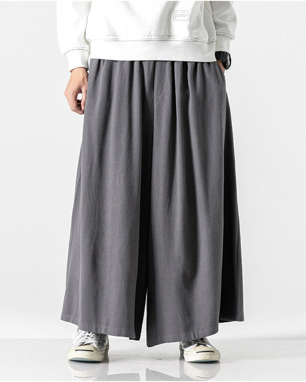 Dark gray extra-wide linen-cotton skirt pants worn with a white sweatshirt and white sneakers