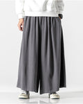 Dark gray extra-wide linen-cotton skirt pants worn with a white sweatshirt and white sneakers